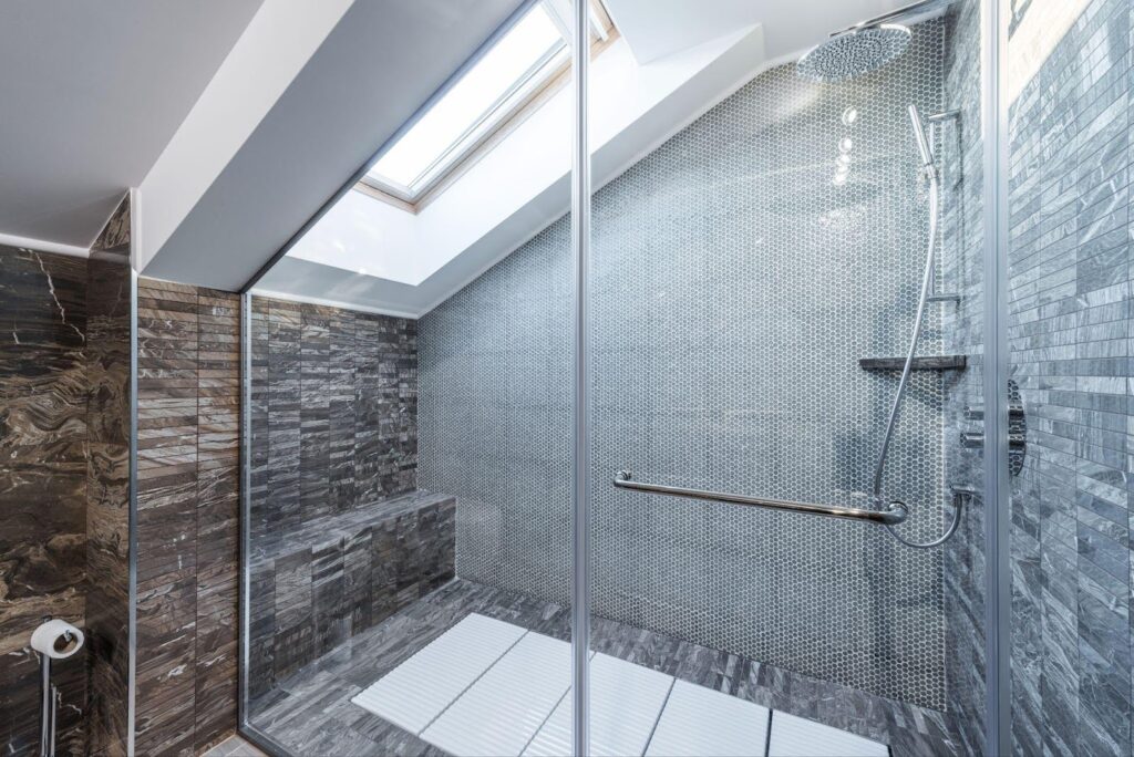 A stylish bathroom showcasing a glass shower alongside a large walk-in shower