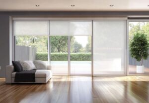 A cozy living room featuring a couch and large sliding glass doors that open to an outdoor space