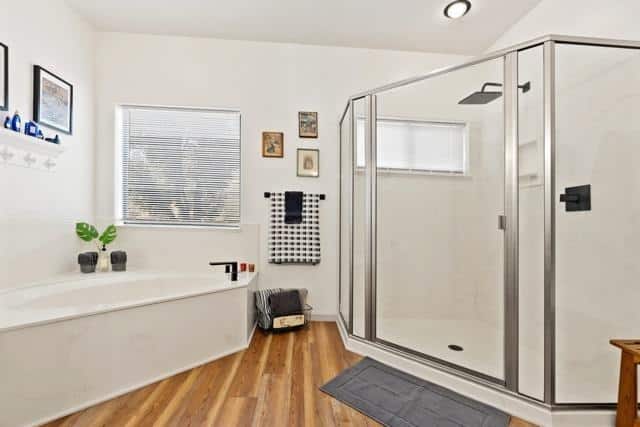 A bathroom featuring a shower sink and toilet with neutral-colored tiles and modern fixtures