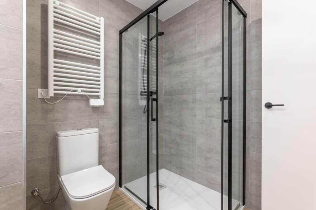 Modern bathroom featuring a sleek shower and a contemporary toilet in a minimalist design